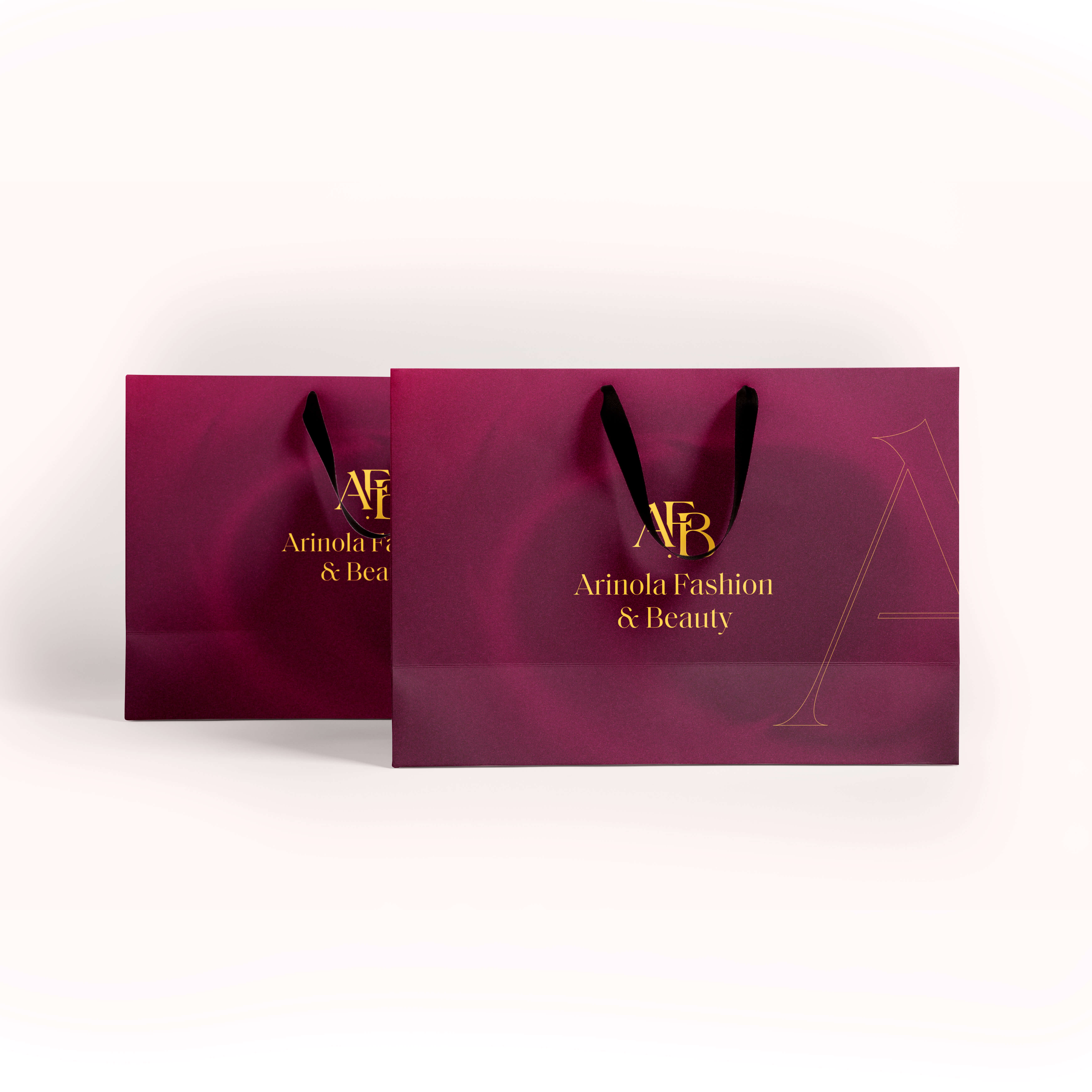 Arinola magenta luxury shopping bags with gold branding